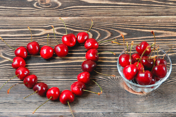 Cherries in the Cup on Wooden Table
