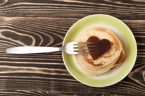 Stack of pancakes on wooden board — Stock Photo, Image