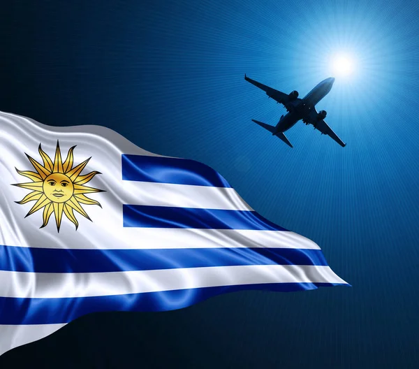 乌拉圭的丝绸国旗在夜间与飞机在天空的背景 3D插图 — 图库照片
