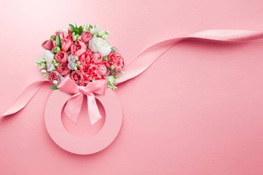 March 8 greeting card. Paper number 8 on a pink background with a bouquet of peonies, silk ribbon isolated pink background