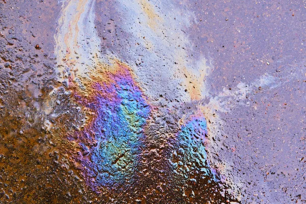 Abstract multicolored stain of gasoline on wet asphalt