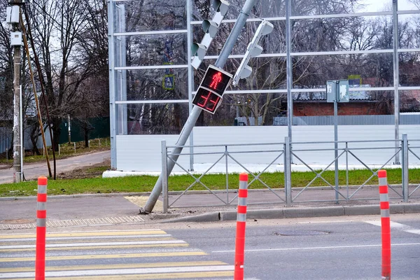 Falling traffic light at a pedestrian crossing. Security threat. Negligence of road services