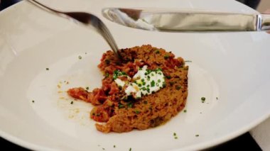 Eating marbled beef tartare with egg. Healthy and delicious snack