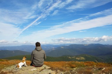 Man and dog traveling in nature clipart