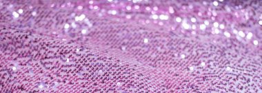 Pembe mor parlak kumaş, pullu, soyut arkaplan. Yakın plan...