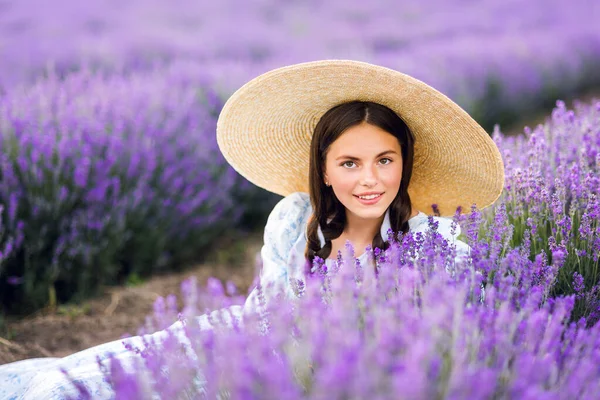 Portrait of beautiful young woman in purple lavender field. France, Provence.