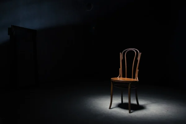 Lonely chair at the empty room Stock Picture