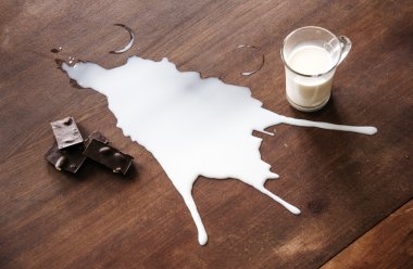 Chocolate and spilled milk on the table.Top view. Eco life concept. clipart