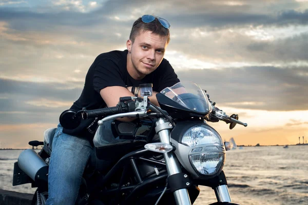 Friendly guy on a motorcycle smiling at the camera