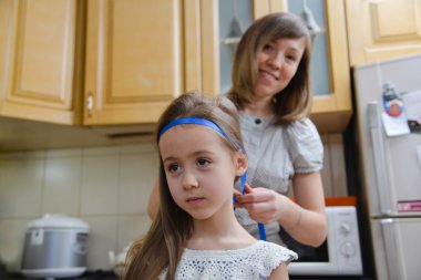 Anne kızın saç modeli yapar