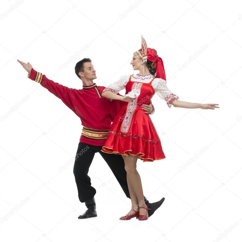 Couple of dancers in russian traditional costumes, embracing on dance pose . 