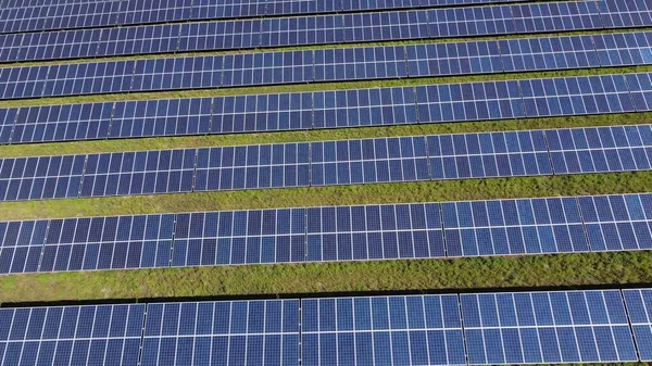 Top down view of ecology green energy solar system panoramic view. Solar panels field at sunny day. Solar energy. Solar panels. Green energy farm generator. Background texture pattern.