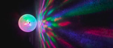 LED yanıp sönen top disko karanlık odasını döndürüyor. Çok renkli, kabartmalı duvar, açık renk. Derinlik alanı, bayanlar.