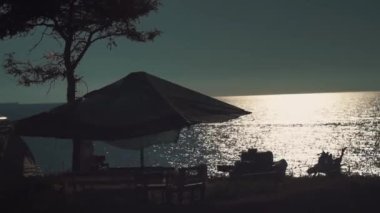 Karadeniz kıyısındaki kampın manzarası, bir tente, banklar, masalar