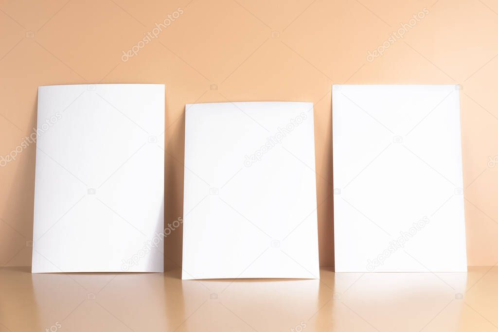 Three blanks white postcards / flyers / invitations mockup on yellow background, copy space