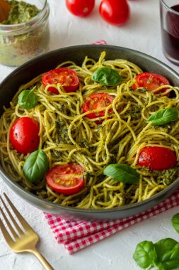 Pesto soslu makarna, domates ve fesleğen. Sağlıklı beslenme. Vejetaryen yemeği.