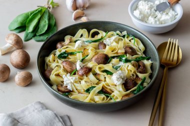 Linguine pasta with mushrooms, white cheese, spinach and garlic. Healthy eating. Vegetarian food. Diet clipart
