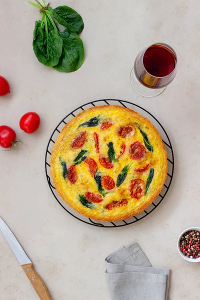 Quiche or pie with tomatoes, spinach and cheese. Healthy eating. Vegetarian food. French cuisine