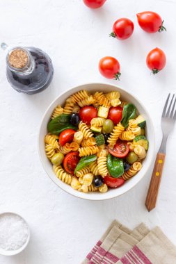 Domatesli makarna salatası, kabak, zeytin ve ıspanak. Sağlıklı beslenme. Vejetaryen yemeği.