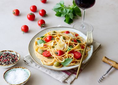 Domatesli spagetti makarna, fesleğen, zeytin ve parmesan peyniri. Sağlıklı beslenme. Vejetaryen yemeği.