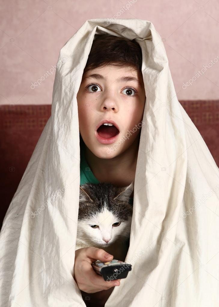 Boy with cat watch horror movie Stock Photo by ©Ulianna 100852422