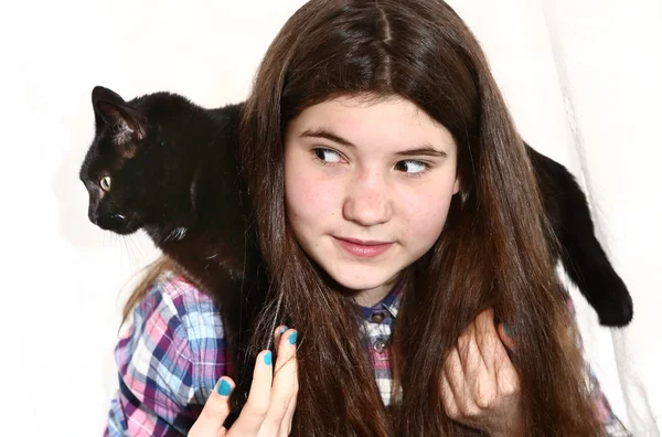 girl with long dark brown thick hairs hold cat