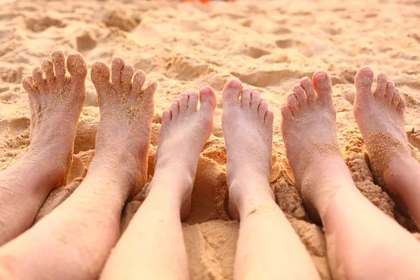bare feet on the sandy  beach close up photo