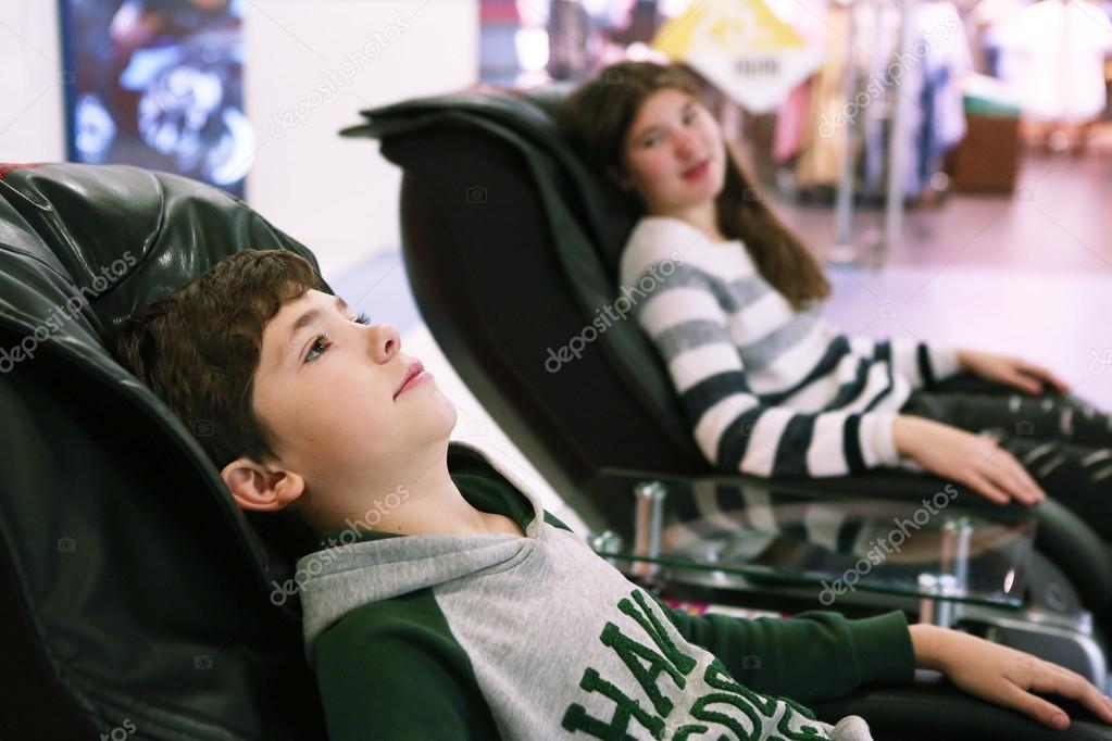 Teen Siblings Brother And Sister In Massage Chair Stock Photo Teen Siblings Brother And Sister In Massage Chair Stock Photo