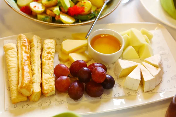 Prato de queijo com uvas de pires de mel e pão — Fotografia de Stock
