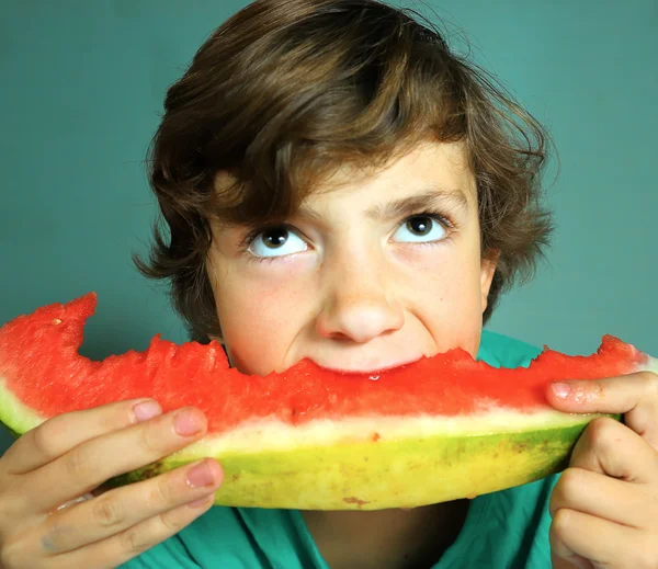 Preteen bonito menino comer melancia — Fotografia de Stock