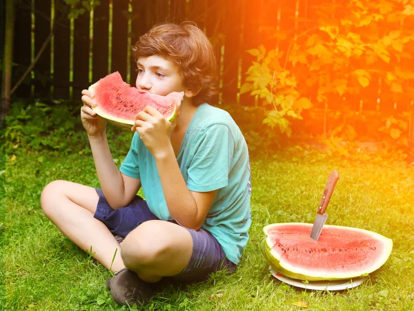 Stilig tonårspojke äta vattenmelon — Stockfoto