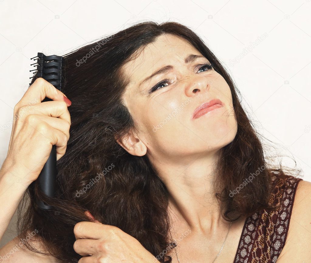 pretty young woman with brush comb stuck in hair