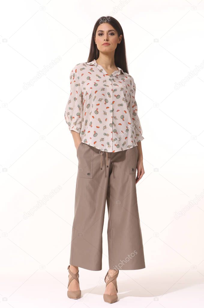  Indian business woman executive posing in formal culottes trousers and printed blouse heels shoes full body photo copy space isolated on white