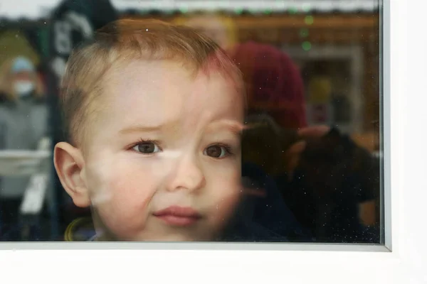 Cute toddler baby boy close up portrait with flat nose agains the window — Stock Photo, Image