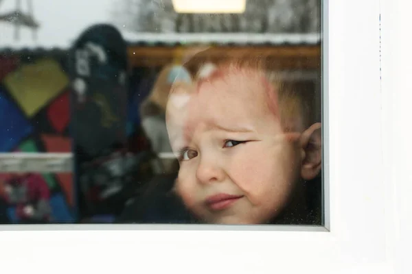 Cute toddler baby boy close up portrait with flat nose agains the window — Stock Photo, Image