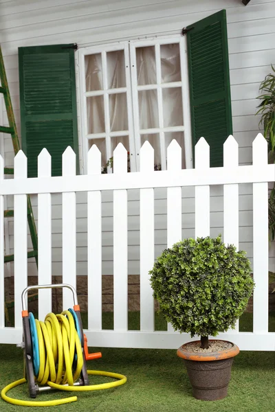 Beautiful exterior fragment of mansion house with window and hose — Stock Photo, Image