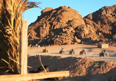 quad bike safari trip into desert in Egypt clipart