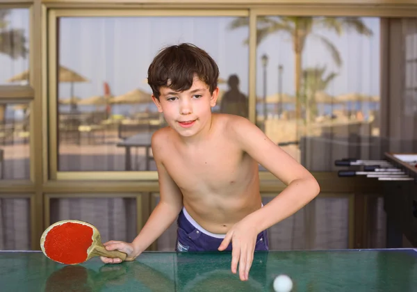 Preteen menino bonito jogar ténis de mesa no hotel resort de praia — Fotografia de Stock