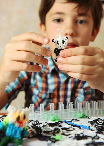 Preteen hansome boy show  the result of his rainbow loom hobby p — Stock Photo, Image
