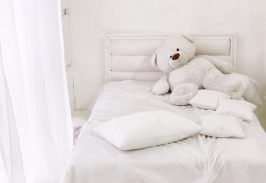 white room corner with bed teddy bear and window with white curt clipart