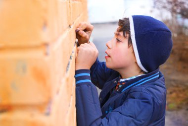 preteen handsome boy try himself as a graffiti artist on the yel clipart