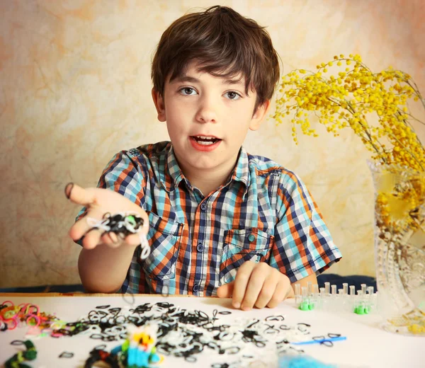 Preteen hansome boy show  the result of his rainbow loom hobby p — Stock Photo, Image