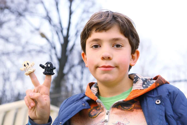 Preteen hansome jongen tonen het resultaat van zijn regenboog weefgetouw hobby g — Stockfoto