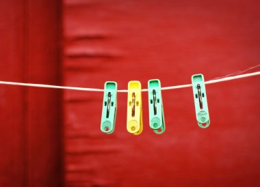 ahşap duvar arka plan üzerinde renkli plastik elbise-peg asmak