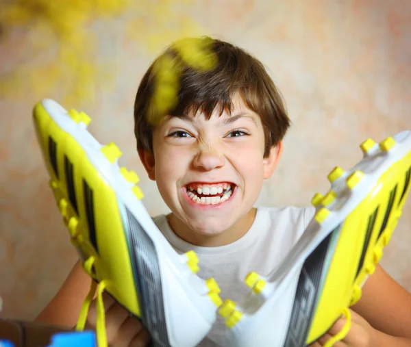 Teen handsome boy with brand new yellow football boots close up — Stock Photo, Image