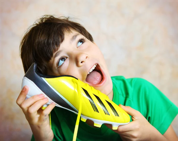 Teen handsome boy with brand new yellow football boots close up — Stock Photo, Image