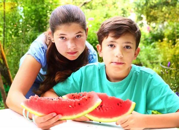 Cute siblings couple with water melon slices — Stock Photo, Image