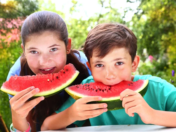 Lindos hermanos pareja con rodajas de sandía — Foto de Stock