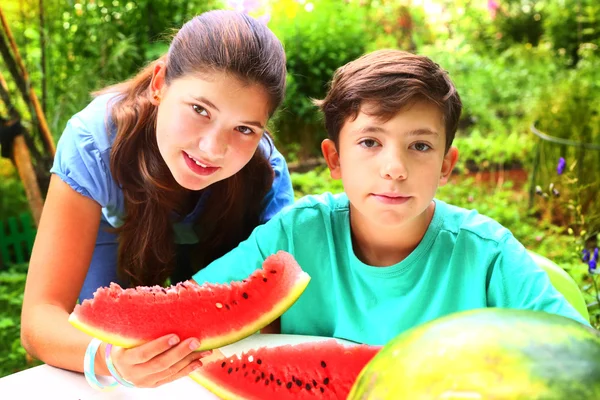 Cute  siblings couple with water melon slices — Stock Photo, Image