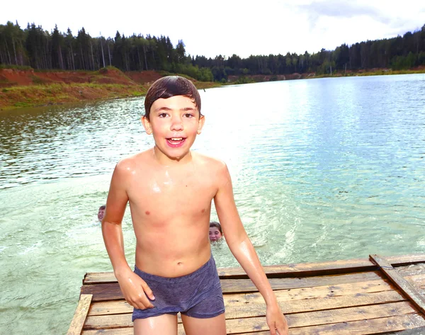 Boy swimming in the lake on their summer country holiday — Stock Photo, Image